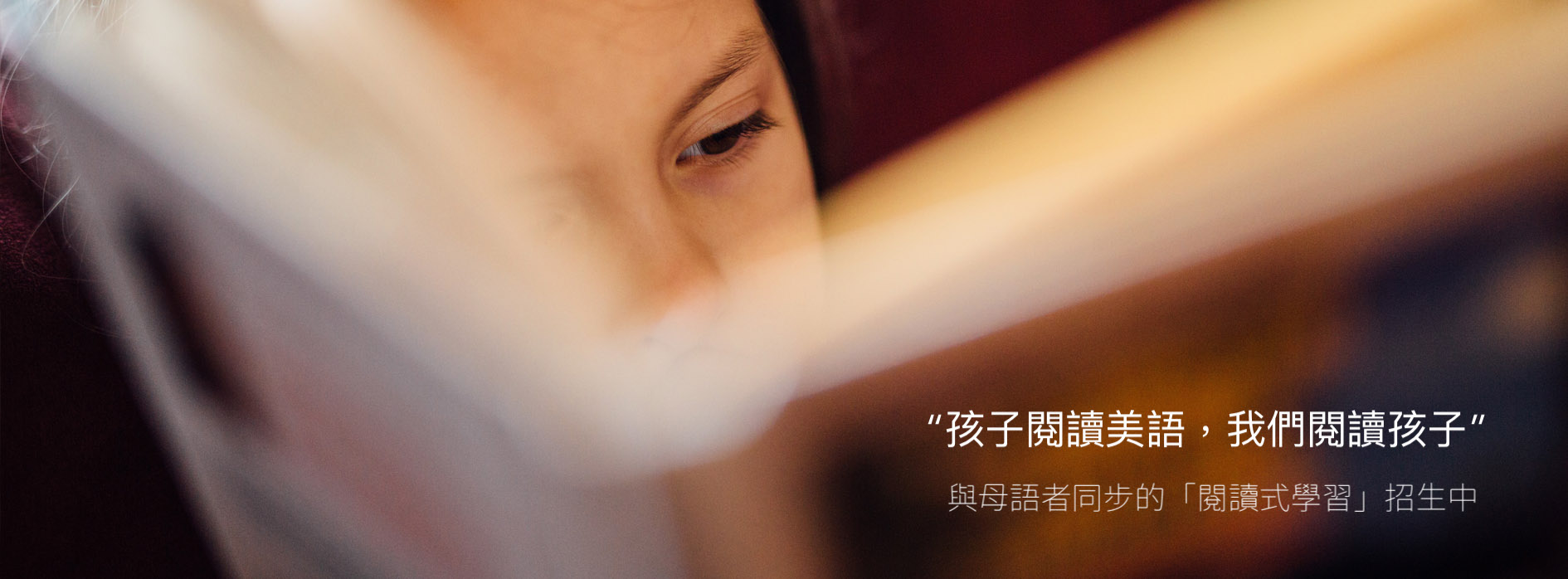 孩子專注閱讀;照片文字:孩子閱讀美語,我們閱讀孩子。與母語者同步的閱讀式學習,招生中。